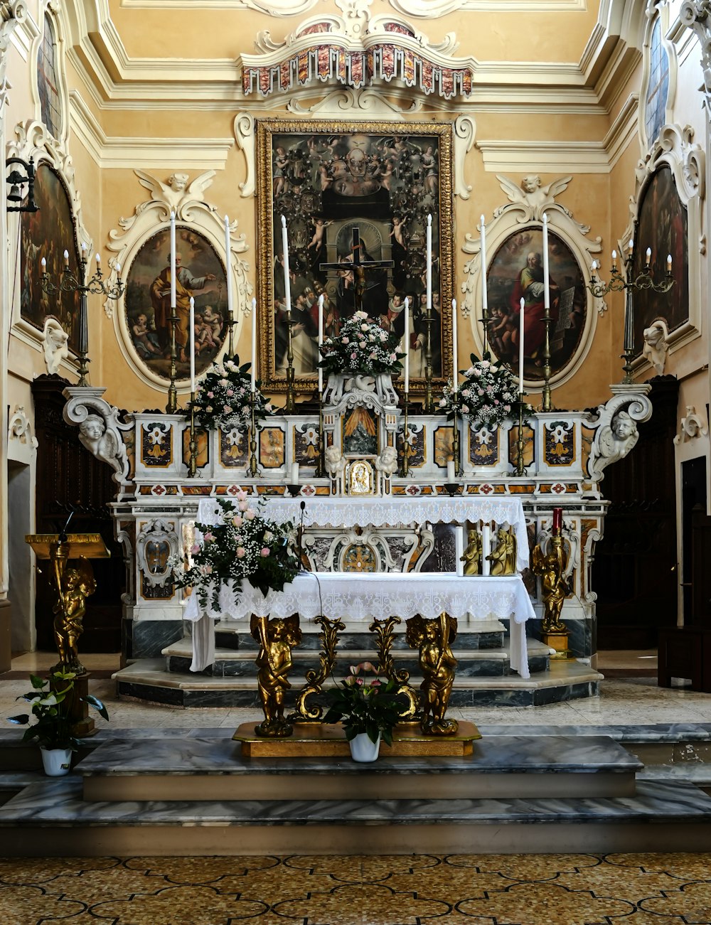 a church altar with a white table cloth on it