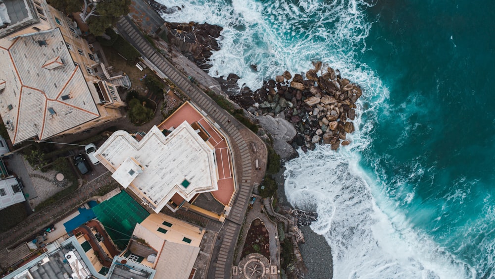 an aerial view of a building next to the ocean