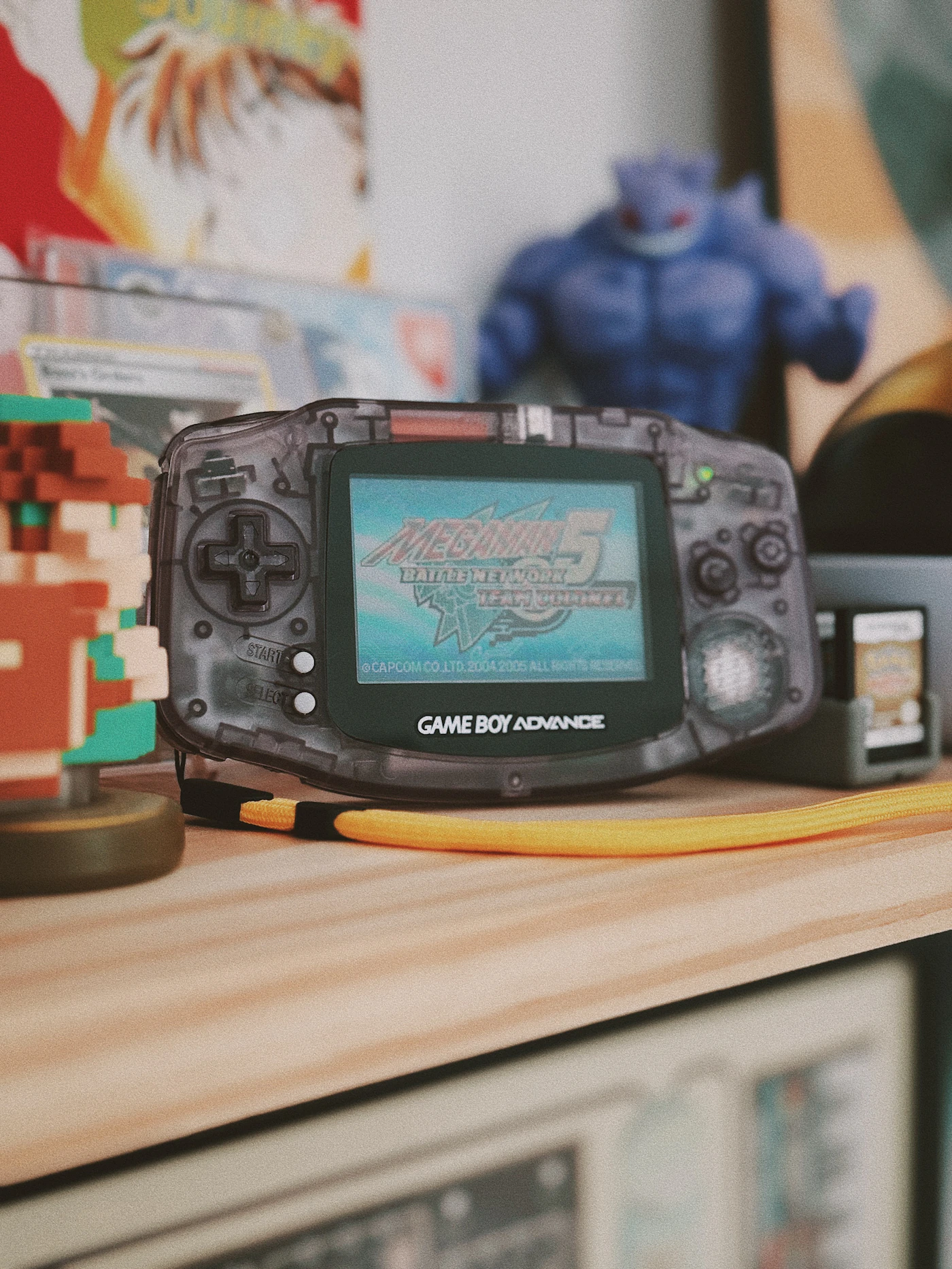Game Boy Advance photographed on a shelf among retro game memorabilia