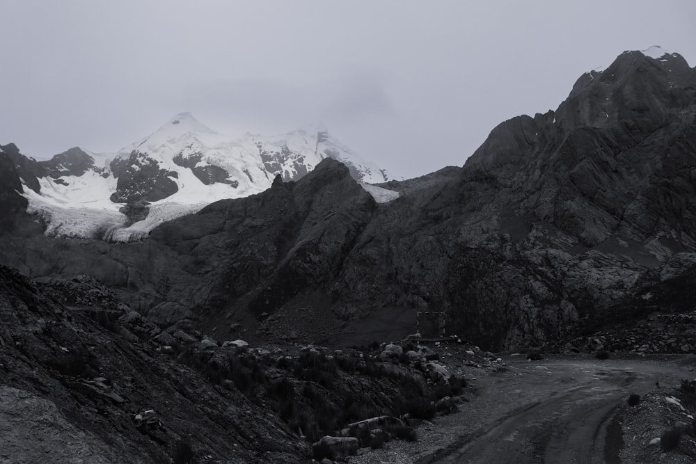 a black and white photo of a snowy mountain