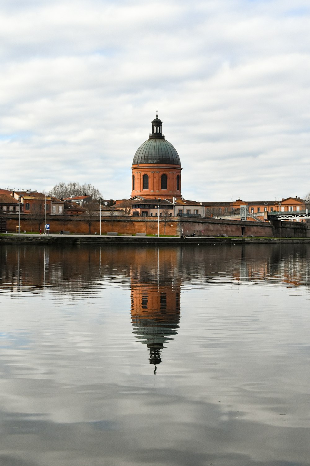 a large body of water with a building in the background