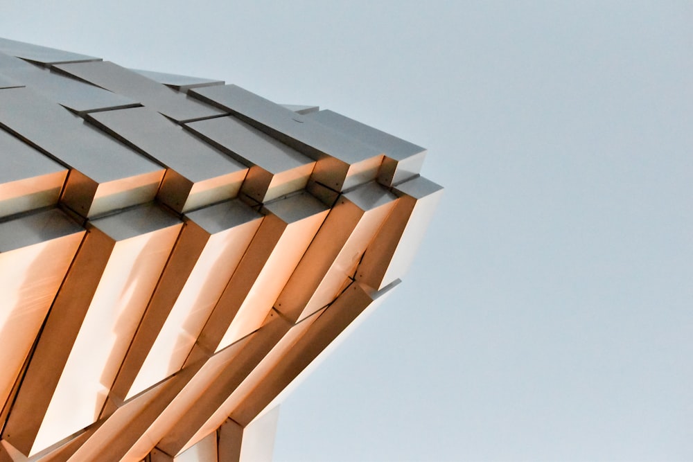 a close up of a metal structure with a sky background