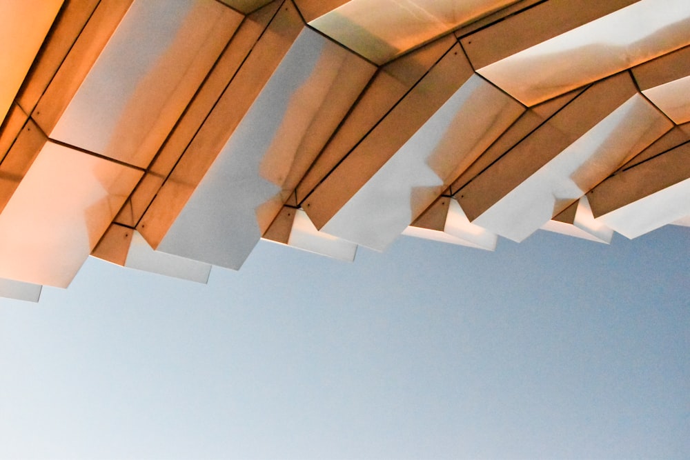 a close up of an umbrella with a blue sky in the background