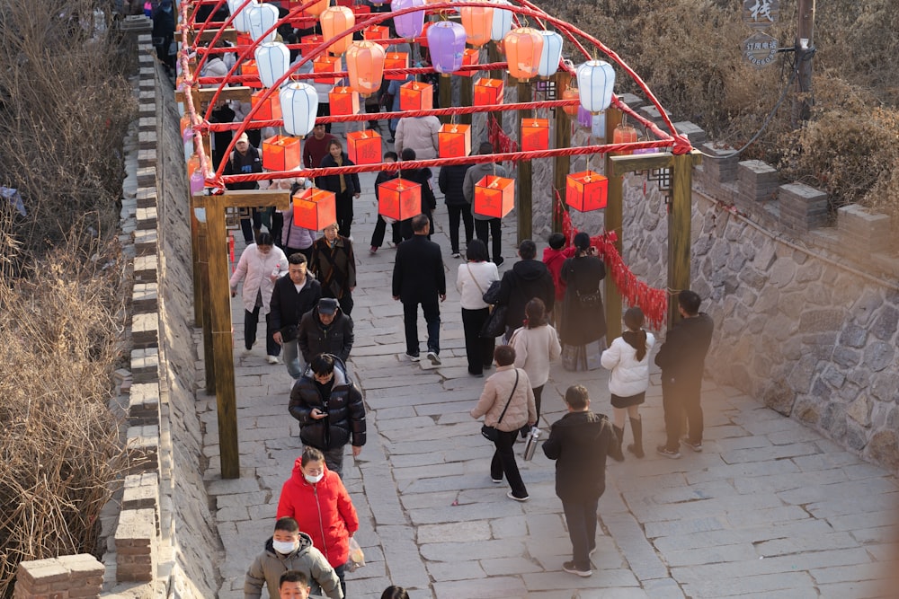 a group of people walking down a stone walkway