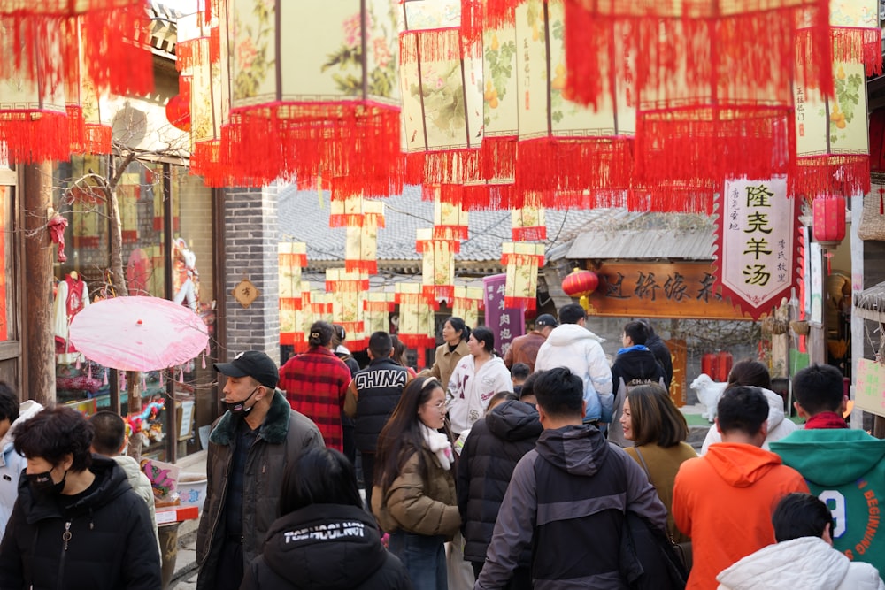 a crowd of people walking down a street