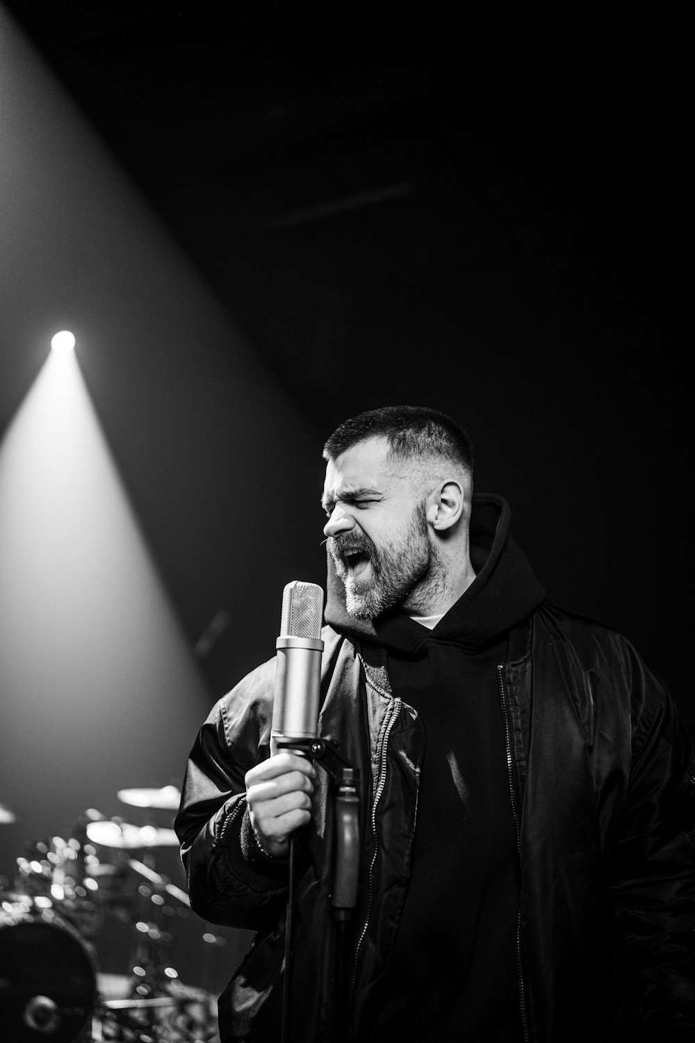 a man standing in front of a microphone