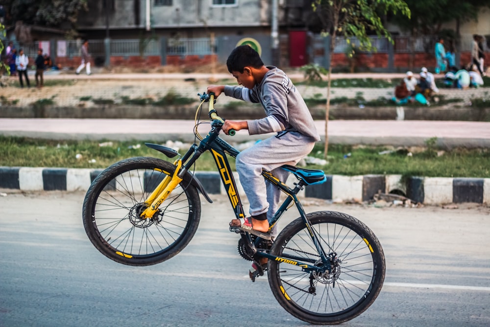 a man riding a bike down a street