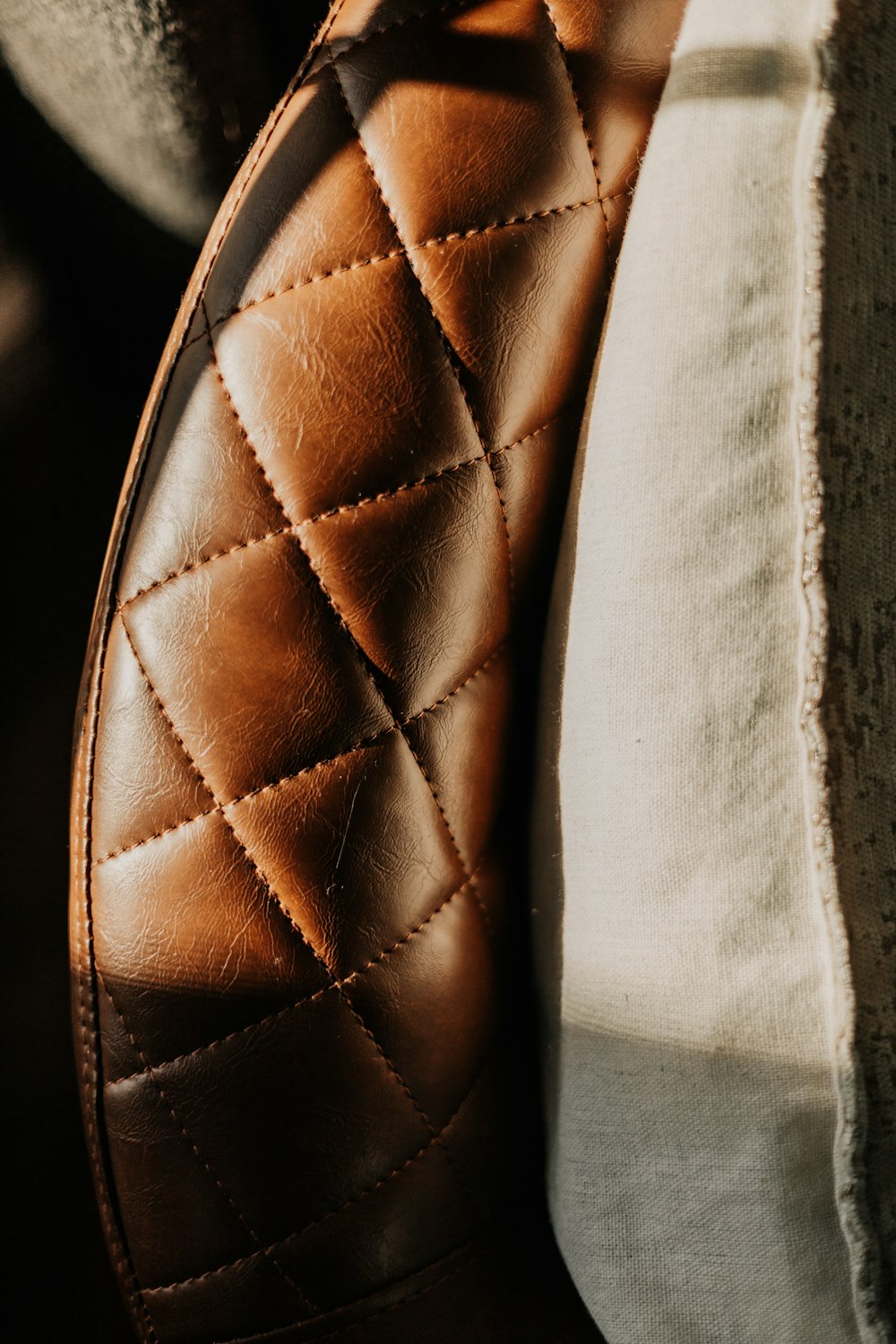 a close up of a brown quilted leather shoe