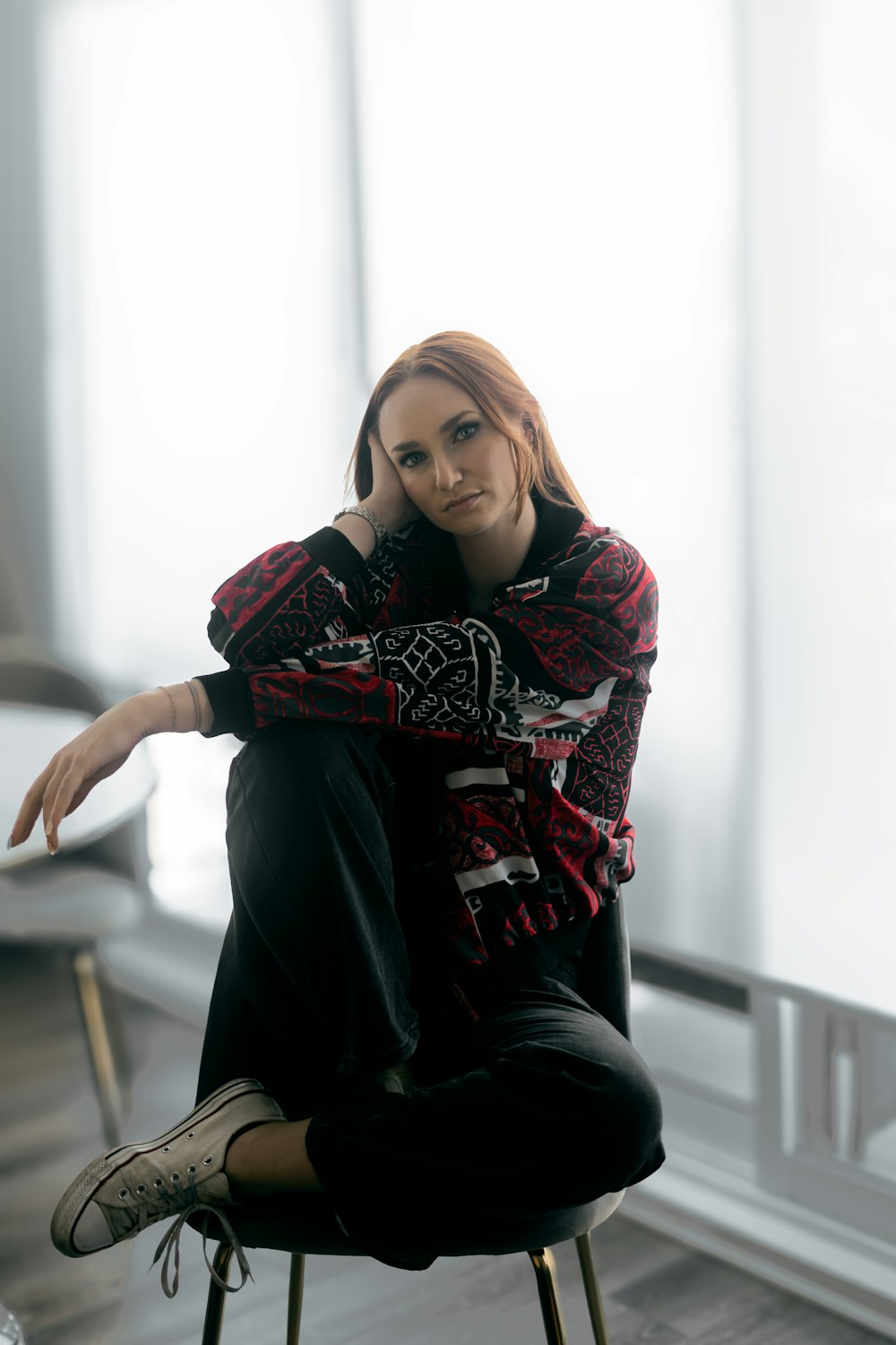 a woman sitting on top of a chair in a room