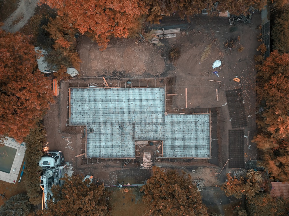 an aerial view of a pool surrounded by trees