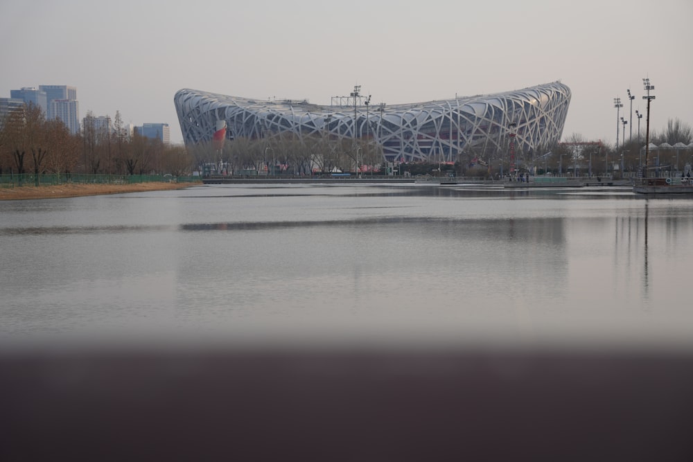 a large body of water with a building in the background