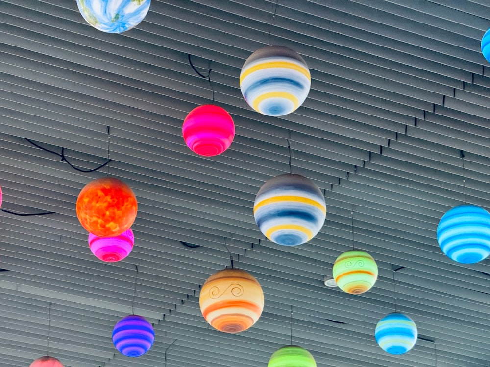 a bunch of colorful lights hanging from a ceiling