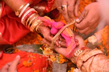 a close up of a person getting henna on another person's hand