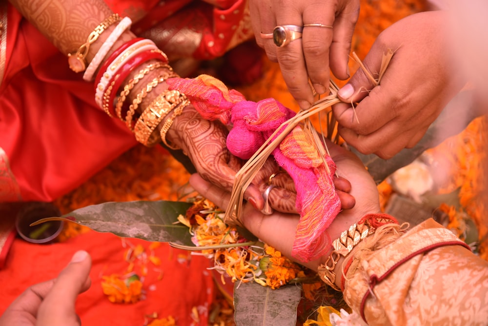 a close up of a person getting henna on another person's hand