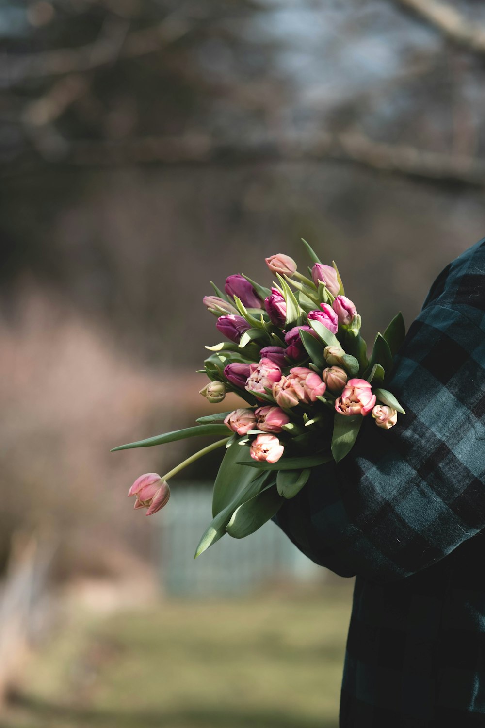 a man holding a bouquet of flowers in his hands