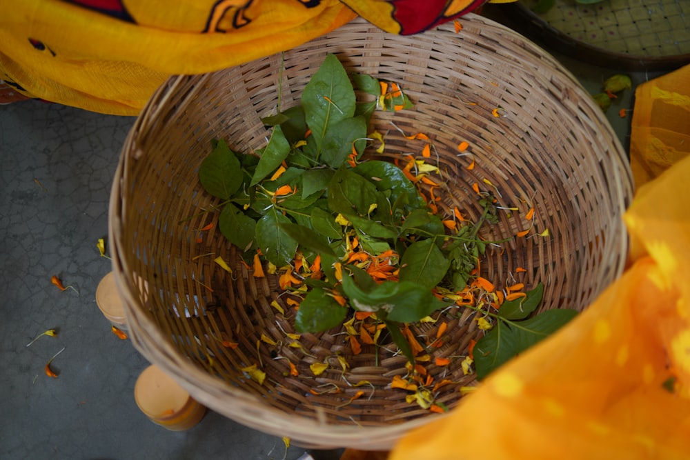 a basket filled with lots of green and yellow flowers