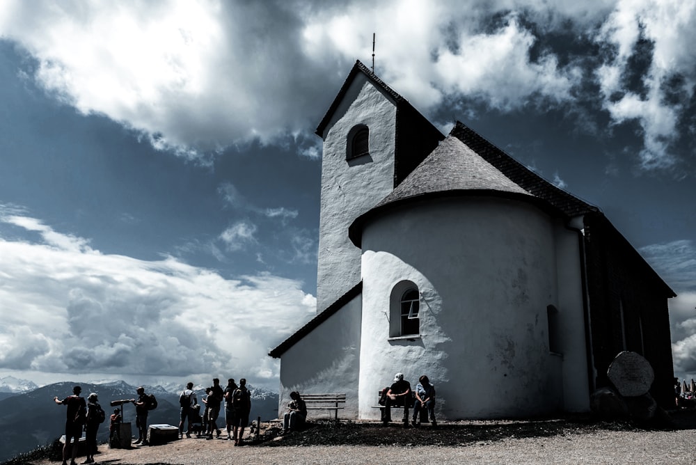 a group of people standing in front of a church