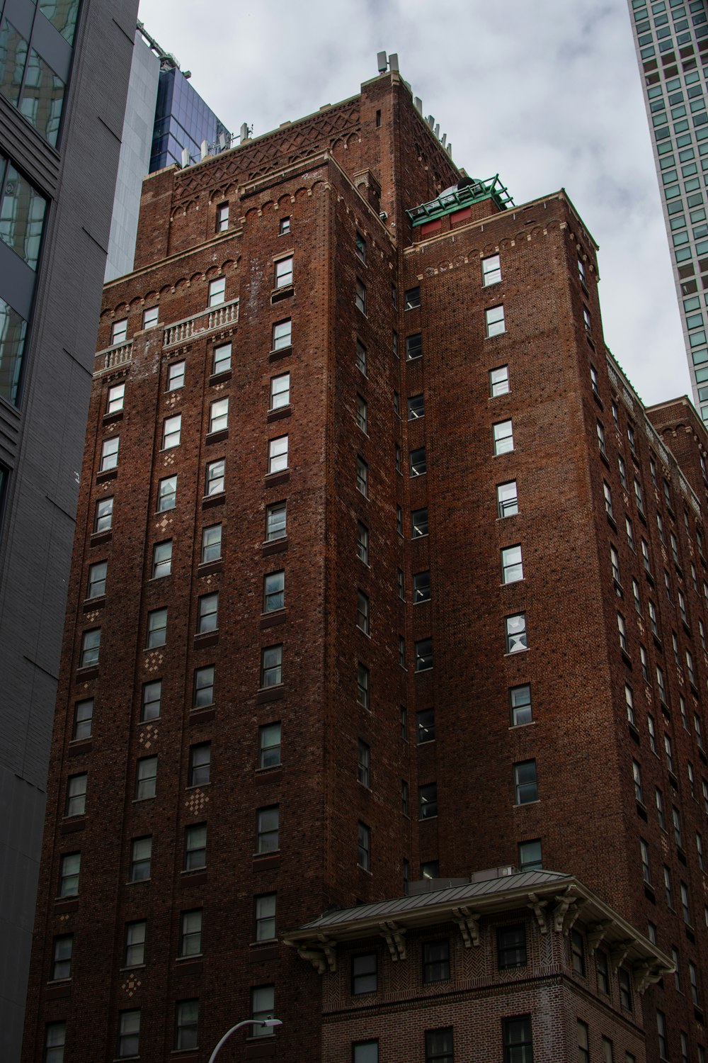 a tall brick building sitting next to a tall building