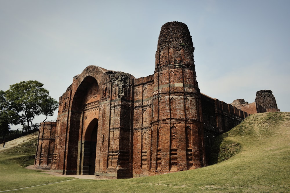 an old brick building sitting on top of a hill