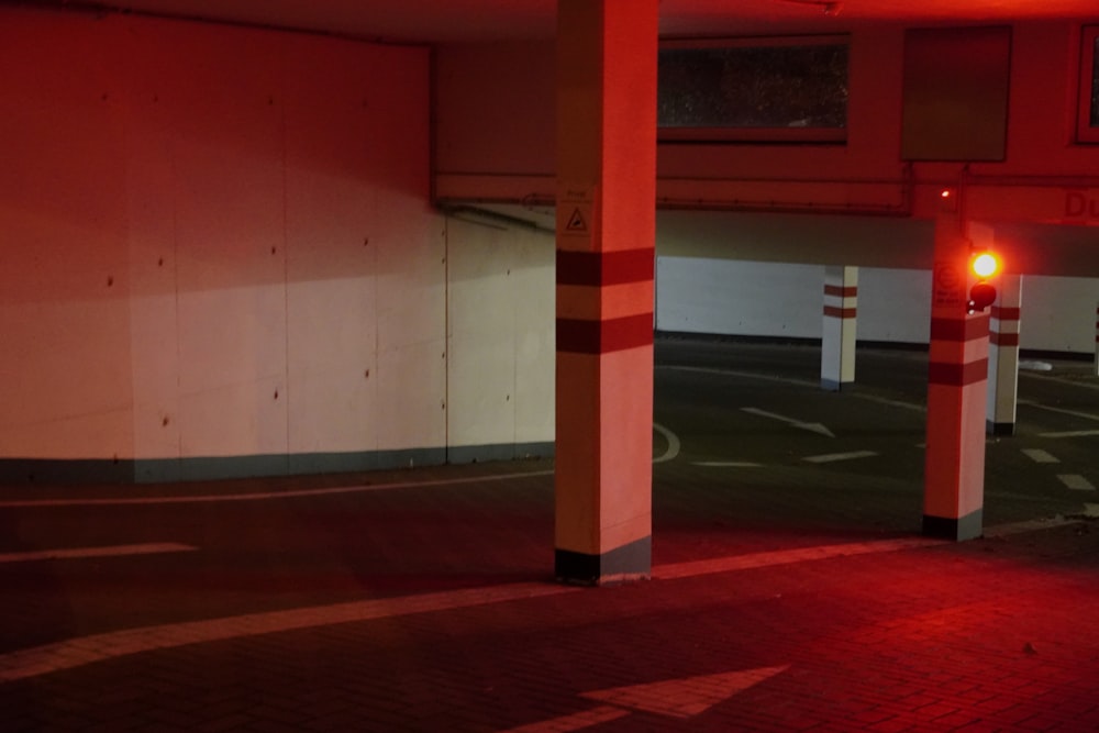 an empty parking garage with a red light