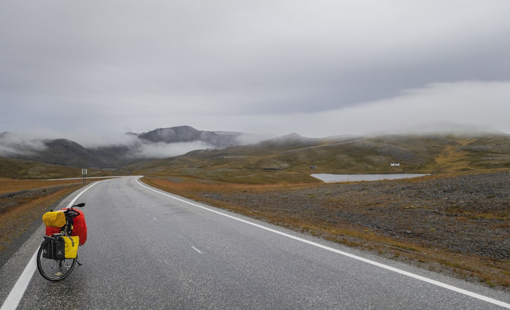 a person riding a bike down a road