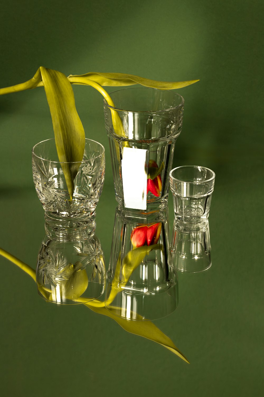 a glass vase with a flower in it