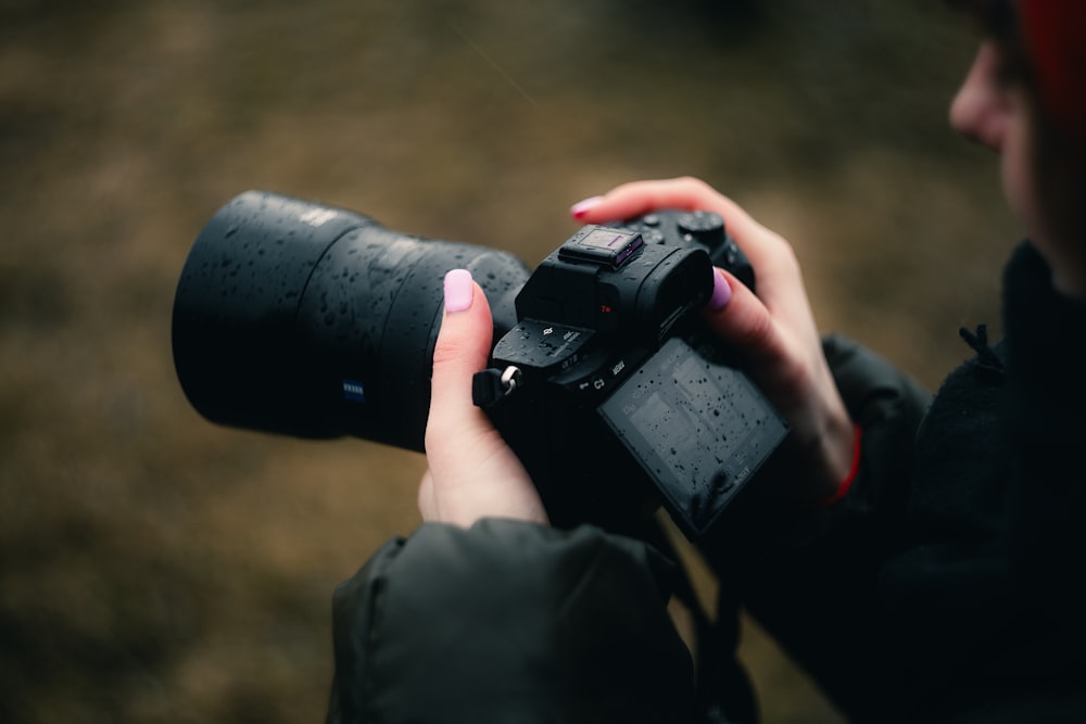 a woman holding a camera in her hands