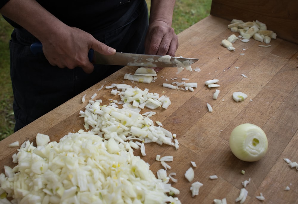 a person chopping onions on a cutting board