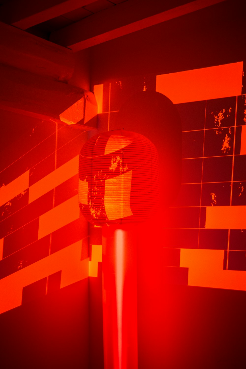 a red and black photo of a clock on a pole