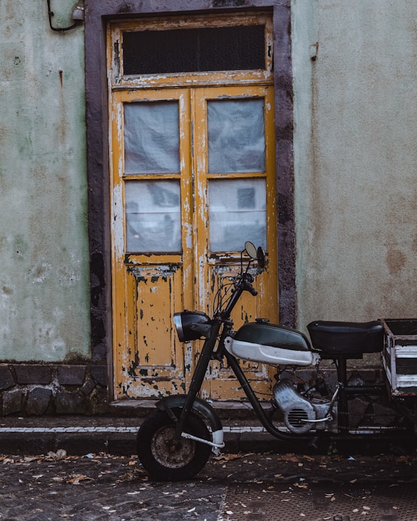 Scooter parked near a colorful doorway