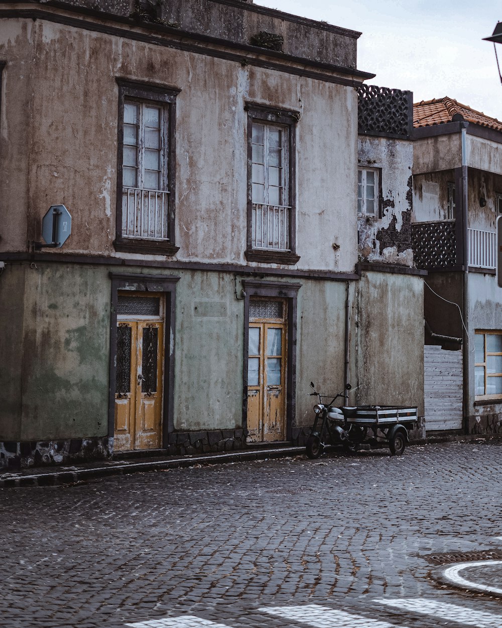 a cobblestone street with old buildings in the background