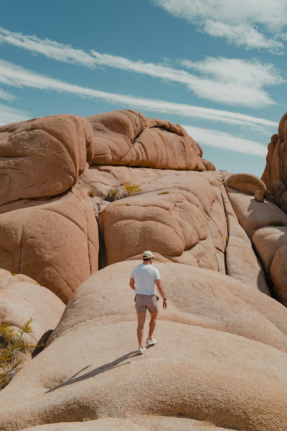 a man standing on top of a large rock formation