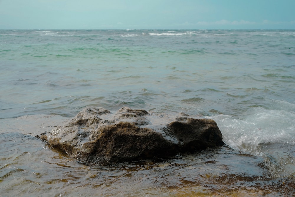 a rock in the middle of the ocean