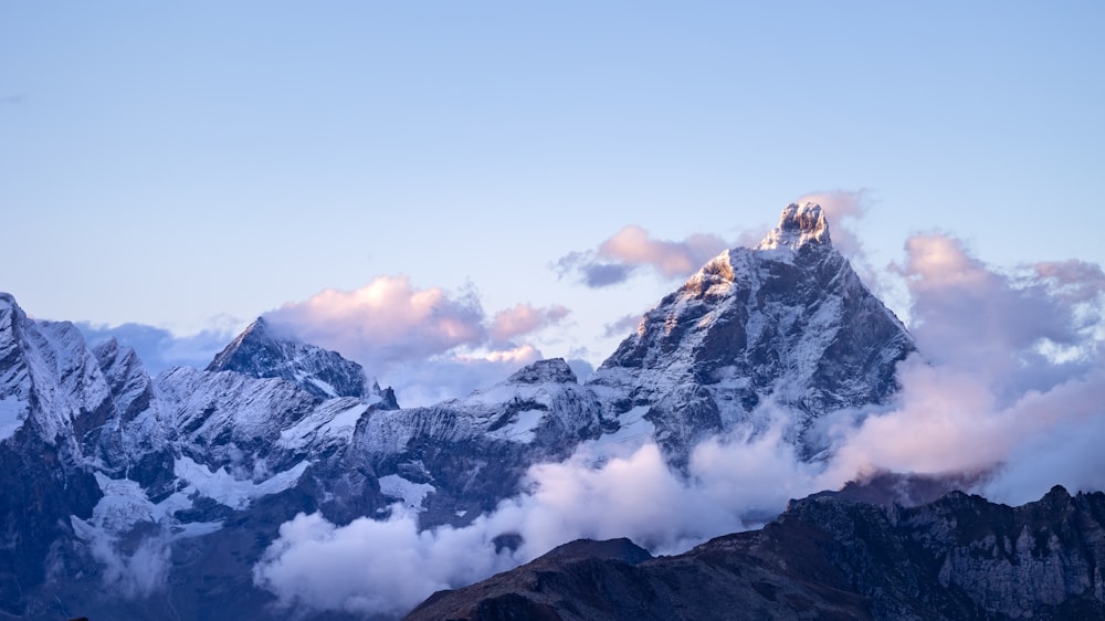 a view of a mountain range with clouds in the foreground