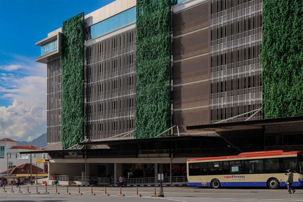 a bus parked in front of a tall building