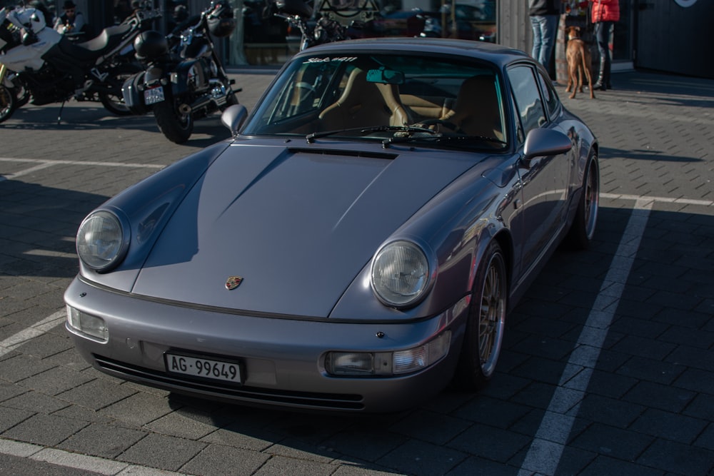 a silver sports car parked in a parking lot