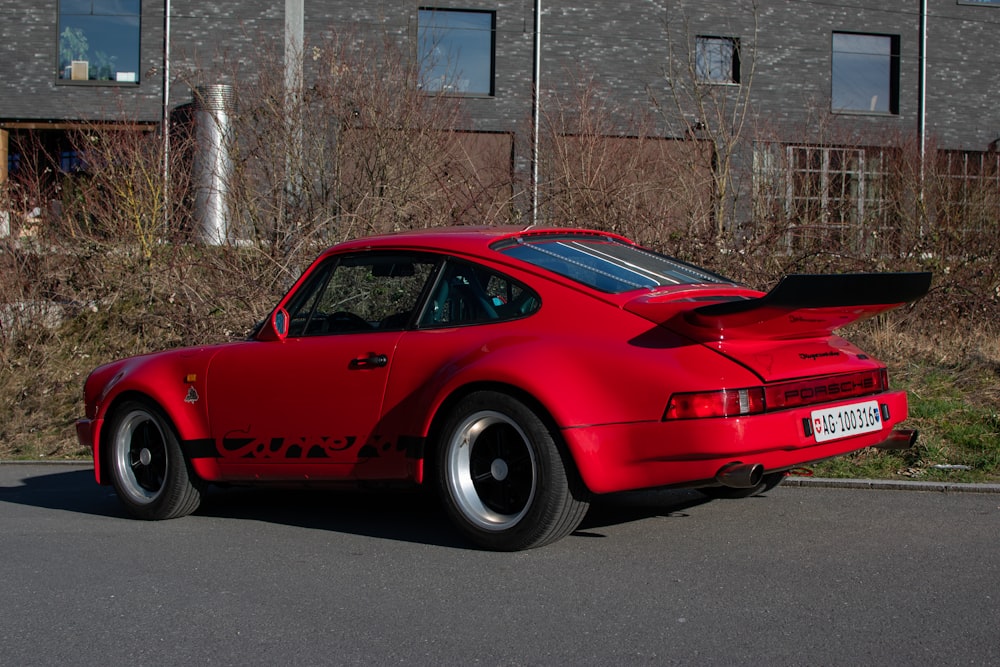 a red sports car parked on the side of the road