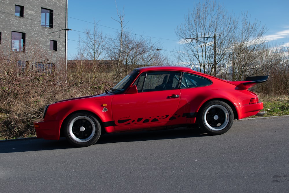 a red sports car parked on the side of the road