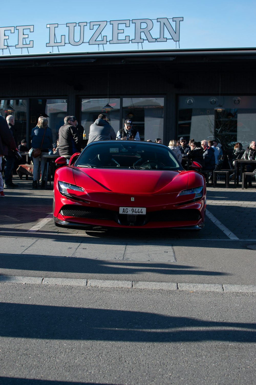 a red sports car parked in front of a building