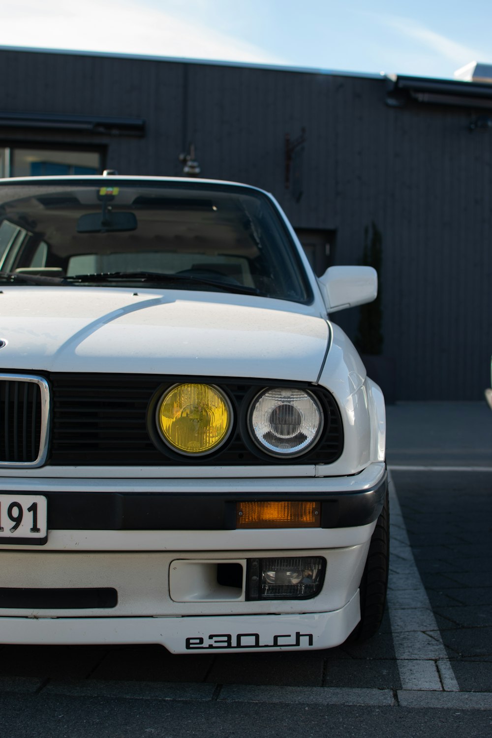 a white car parked in front of a building