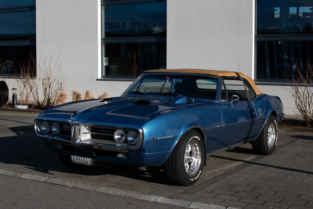 a blue car parked in front of a building