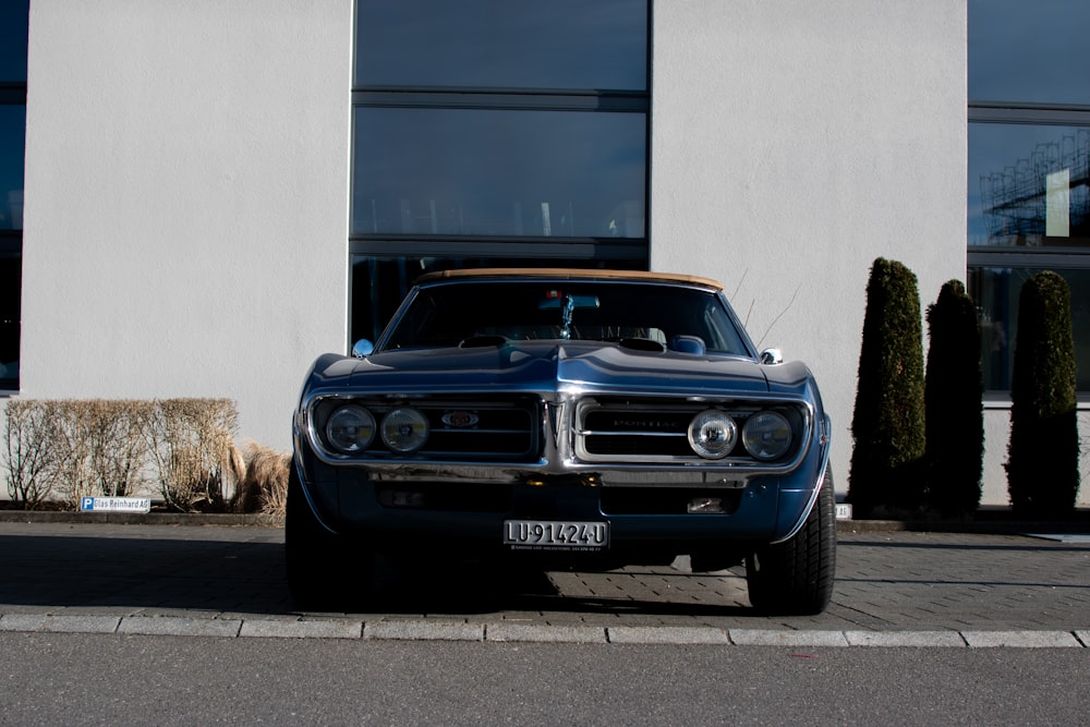 a blue car parked in front of a building