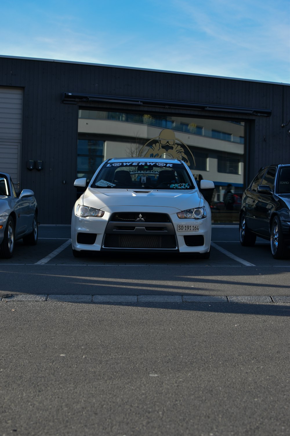 a couple of cars parked in front of a garage