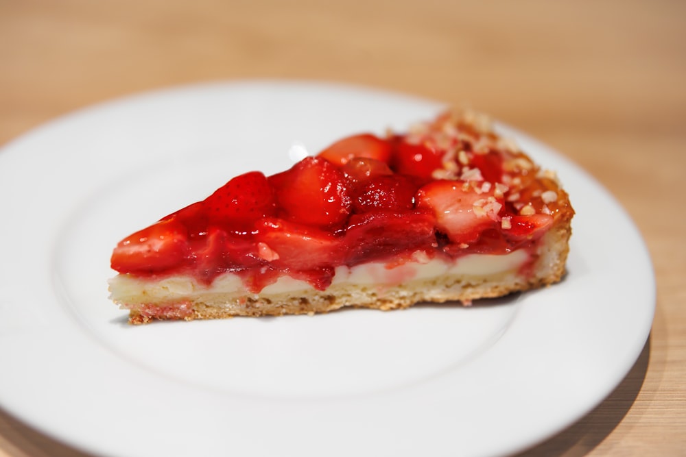 a piece of cheesecake with strawberries on a plate