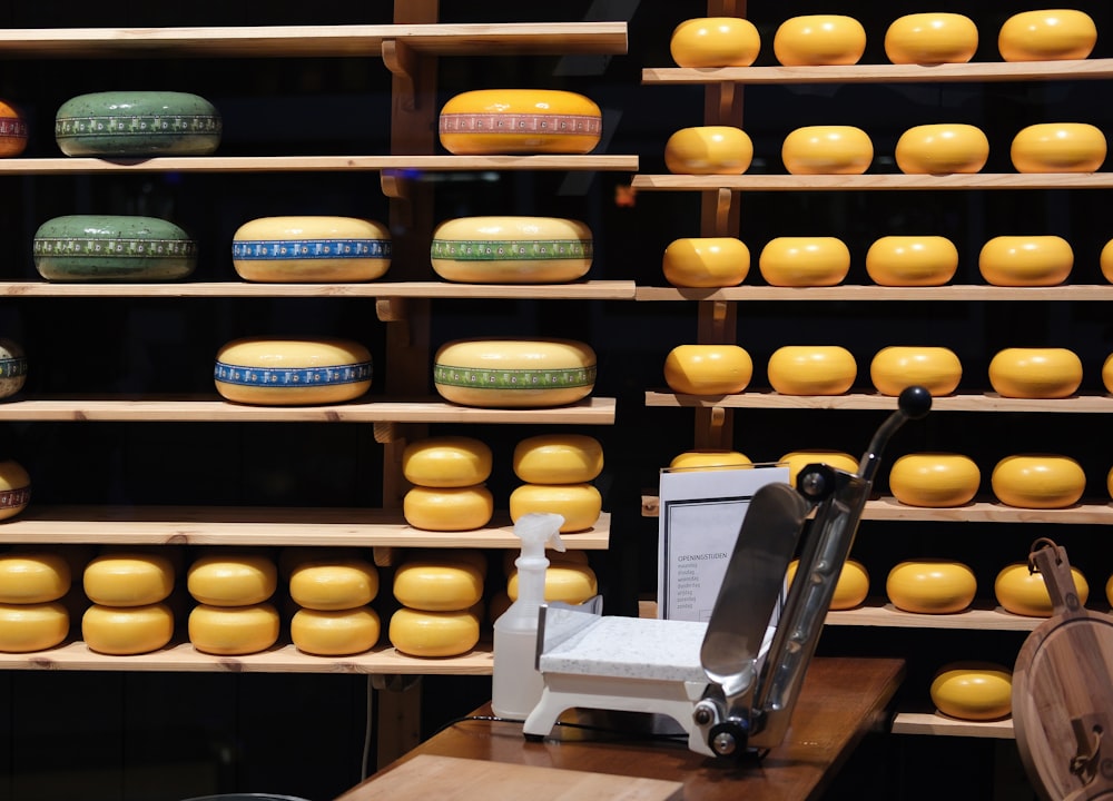 a display of cheese on shelves in a store