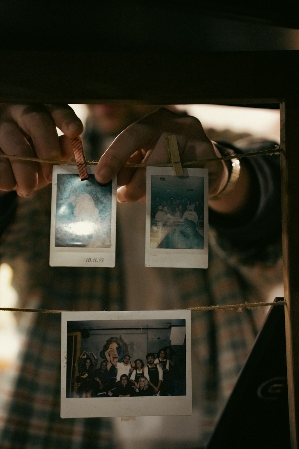 a person holding a string with pictures hanging from it