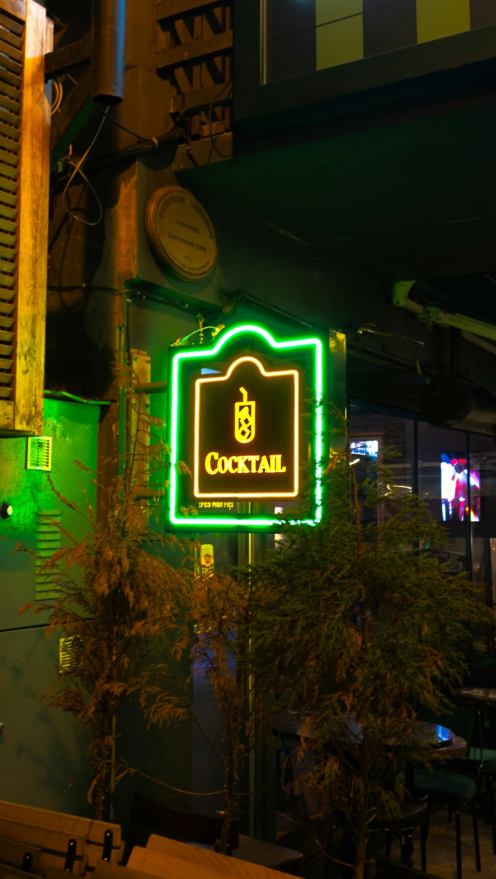 a neon sign is lit up on the side of a building