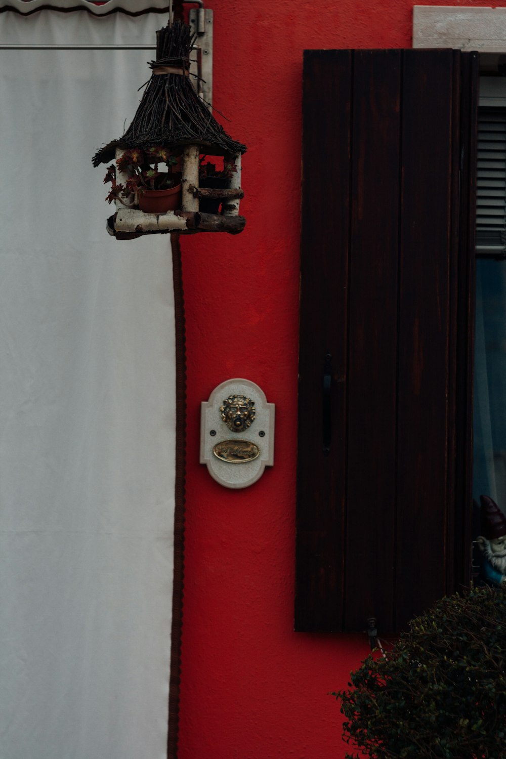 a red building with a clock on the side of it