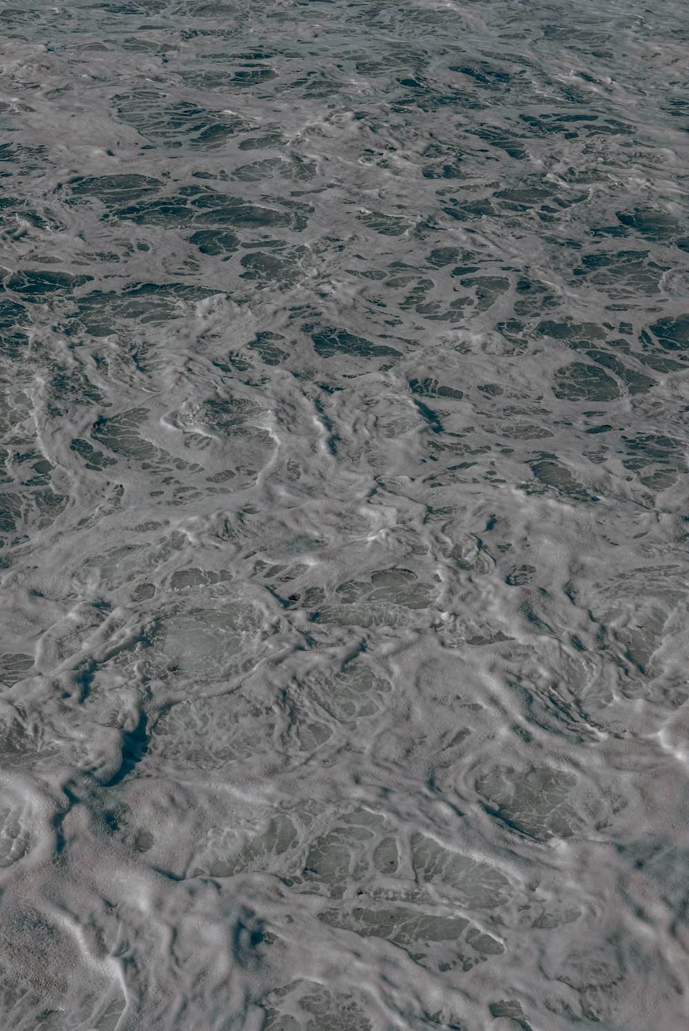 a large body of water with small waves