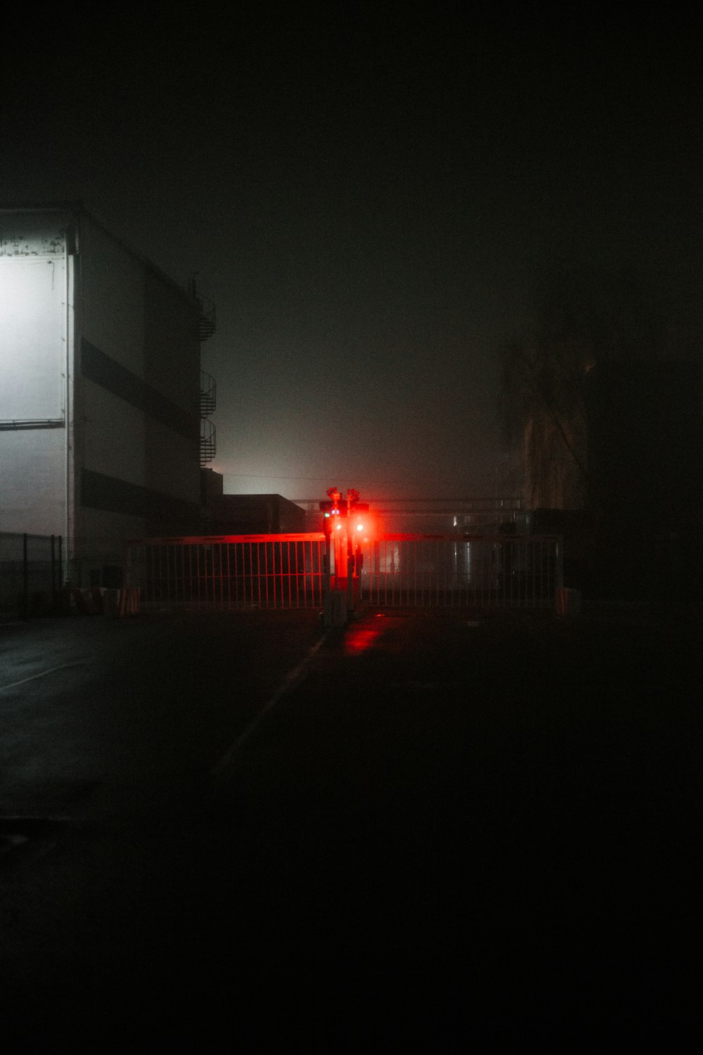 a red traffic light sitting on the side of a road